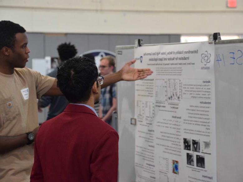 Student pointing at poster board